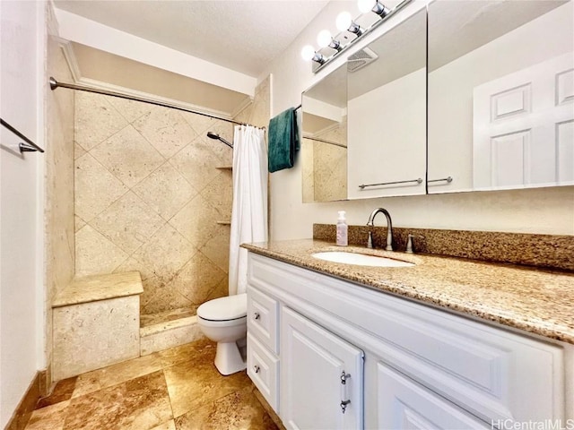 bathroom with vanity, toilet, and walk in shower