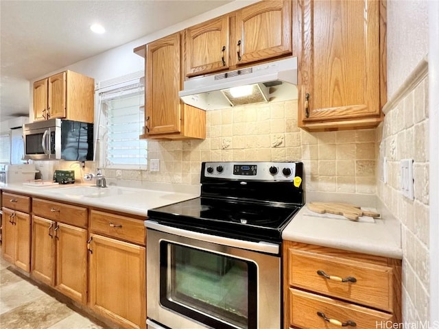 kitchen with backsplash, sink, and stainless steel appliances