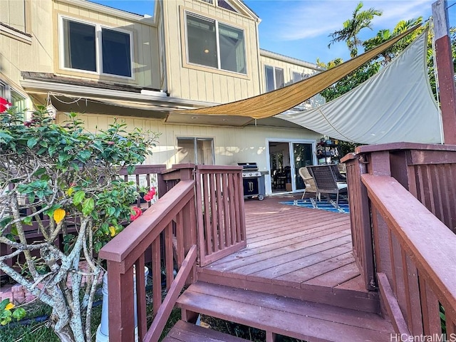 wooden deck with a grill