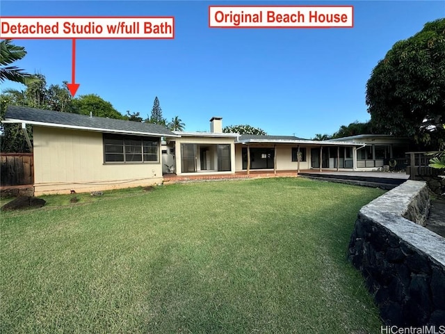 back of house featuring a patio and a lawn