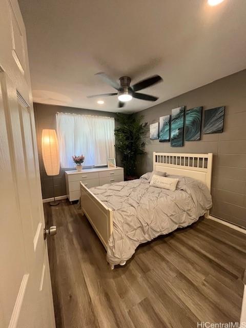 bedroom with ceiling fan and dark hardwood / wood-style floors