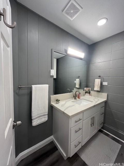 bathroom featuring vanity and wood-type flooring