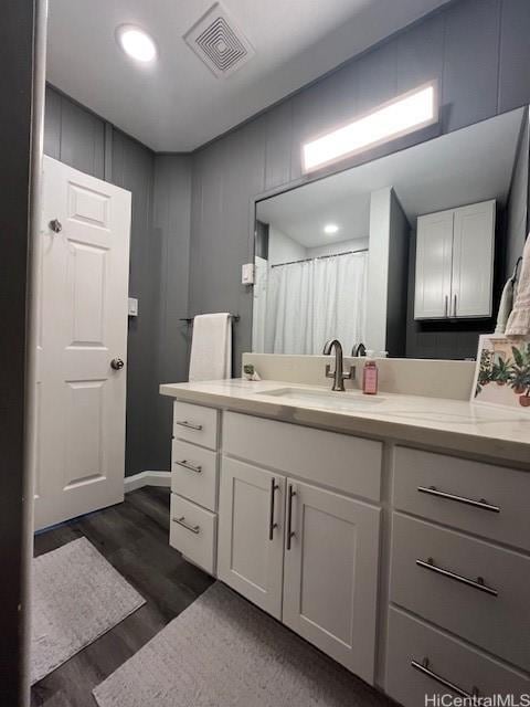 bathroom with vanity and wood-type flooring