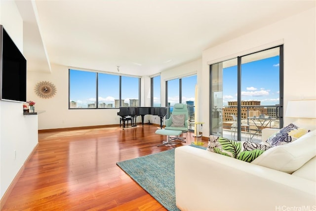 living room with plenty of natural light and hardwood / wood-style flooring