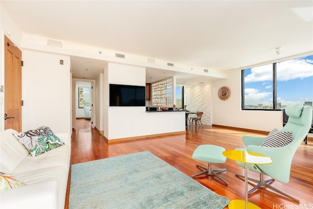 living room featuring hardwood / wood-style floors and floor to ceiling windows