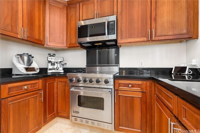 kitchen with stainless steel appliances and light tile patterned flooring