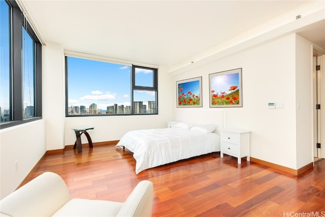 bedroom with hardwood / wood-style flooring