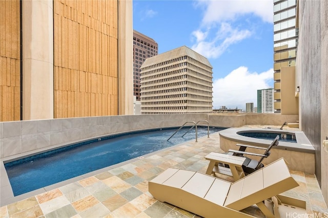 view of pool with a hot tub