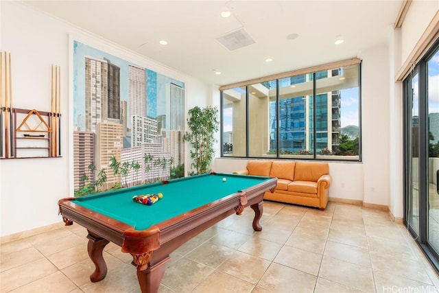 recreation room with ornamental molding, light tile patterned floors, a healthy amount of sunlight, and billiards