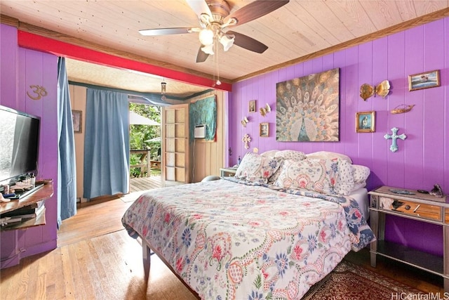 bedroom featuring ceiling fan, wood ceiling, wooden walls, and light hardwood / wood-style flooring