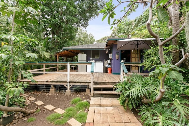 rear view of property featuring a wooden deck