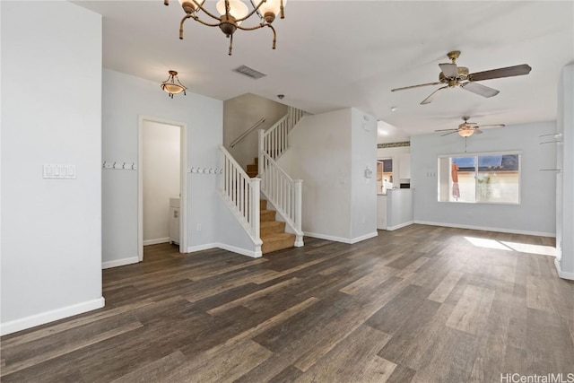 unfurnished living room with baseboards, stairs, visible vents, and wood finished floors