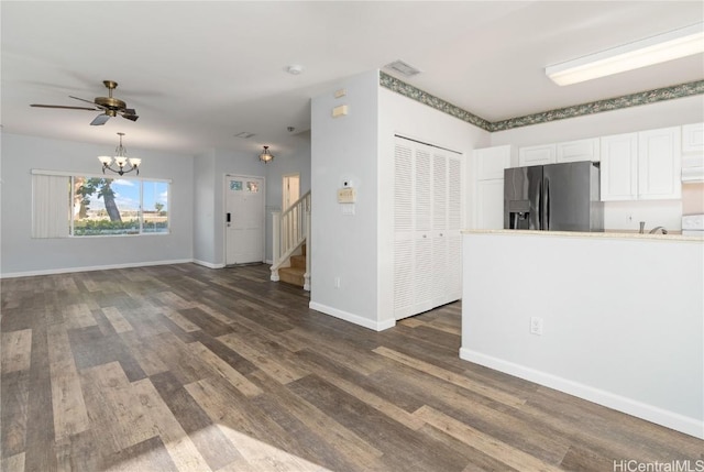 kitchen featuring ceiling fan with notable chandelier, white cabinetry, baseboards, fridge with ice dispenser, and dark wood finished floors