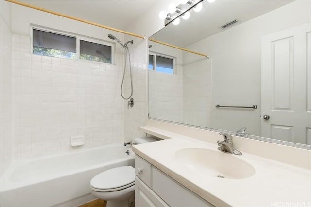 full bath with toilet, vanity, visible vents, and bathing tub / shower combination