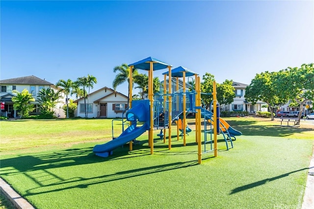 communal playground with a residential view and a lawn