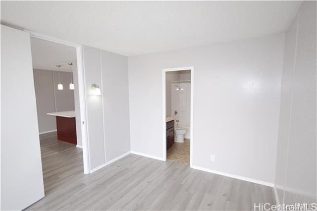 unfurnished room with light wood-type flooring