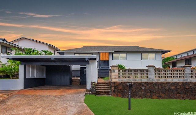 view of front of property with a yard and a carport