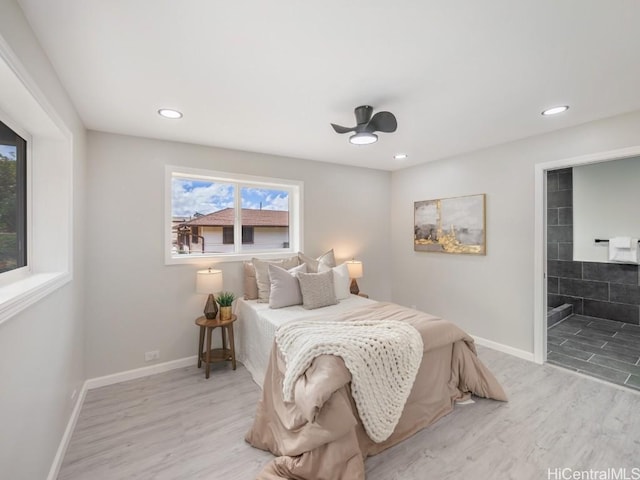 bedroom with light wood-type flooring, ensuite bath, and ceiling fan