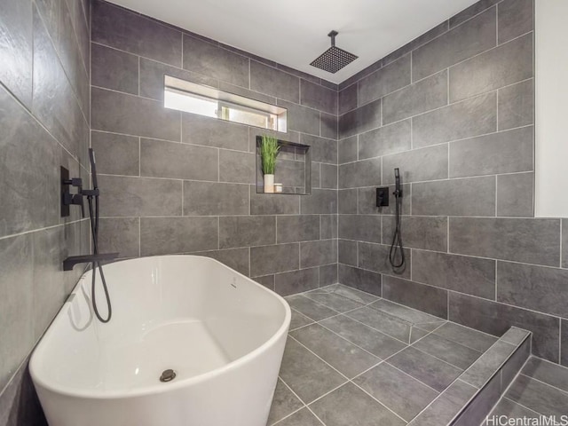 bathroom featuring tile patterned floors, walk in shower, and tile walls