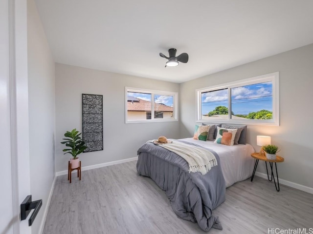 bedroom with light wood-type flooring and ceiling fan