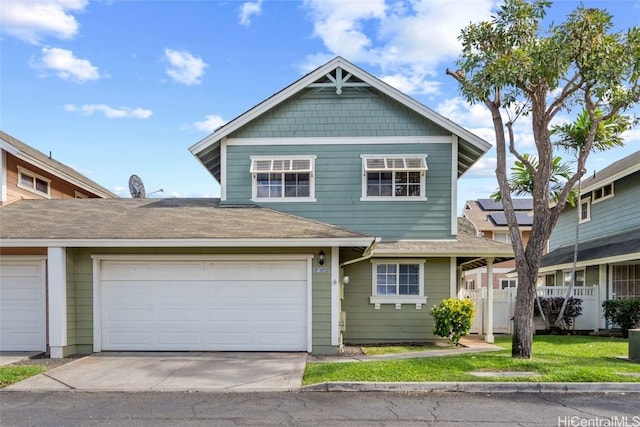 view of front facade featuring a front yard and a garage