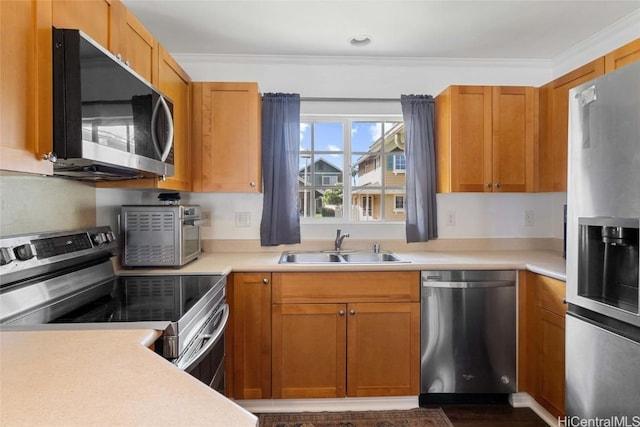 kitchen featuring sink, ornamental molding, and appliances with stainless steel finishes