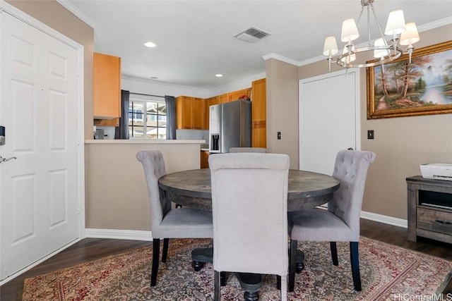 dining space with a chandelier, dark hardwood / wood-style floors, and crown molding