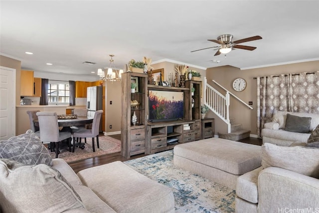 living room with hardwood / wood-style floors, ceiling fan with notable chandelier, and ornamental molding