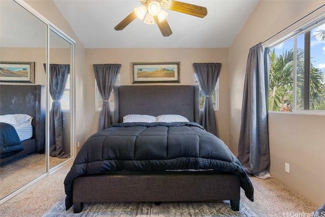 bedroom with ceiling fan, a closet, carpet, and lofted ceiling