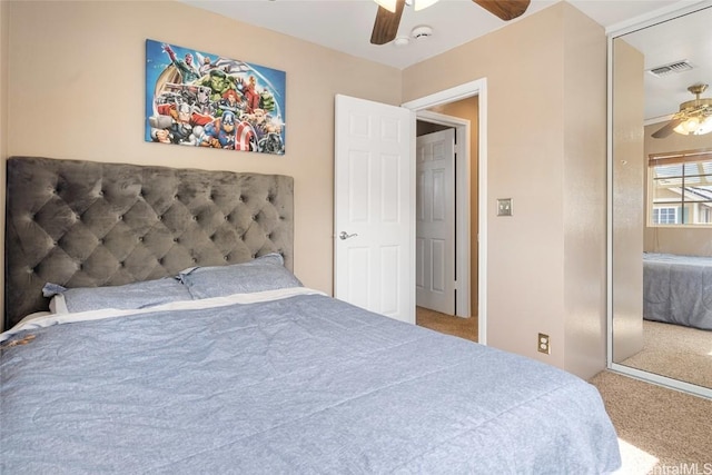 bedroom featuring ceiling fan, a closet, and carpet