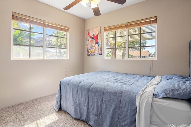 bedroom featuring multiple windows, carpet floors, and ceiling fan