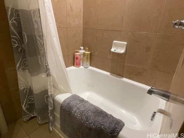 bathroom featuring tile walls and shower / bath combo