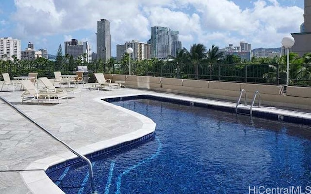 view of swimming pool with a patio