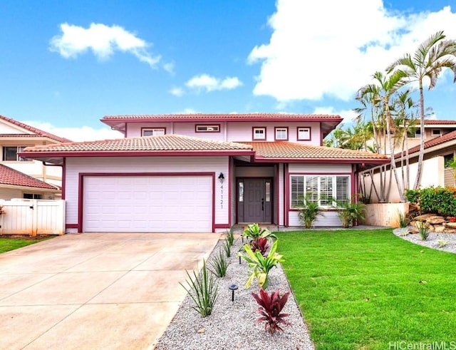 mediterranean / spanish home with a garage and a front yard