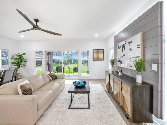 living room with ceiling fan and light hardwood / wood-style floors