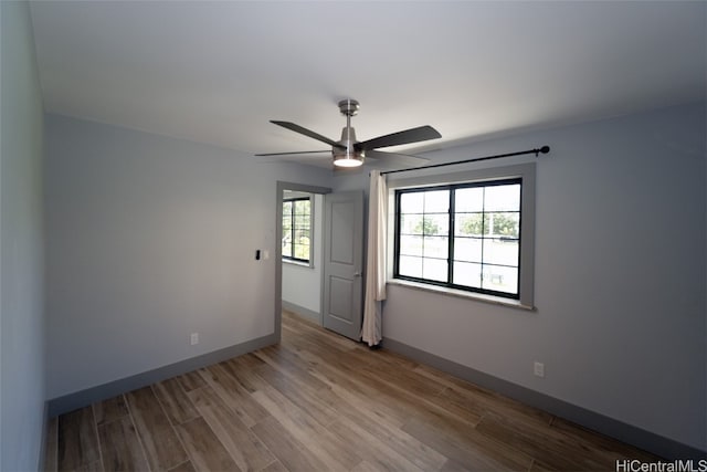 unfurnished room featuring light hardwood / wood-style flooring and ceiling fan