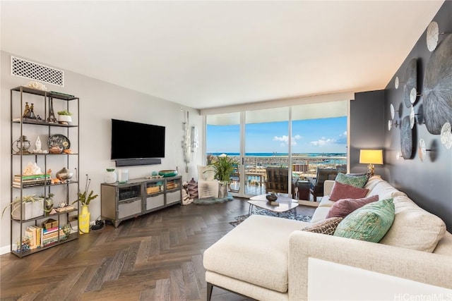 living room featuring dark parquet floors and expansive windows