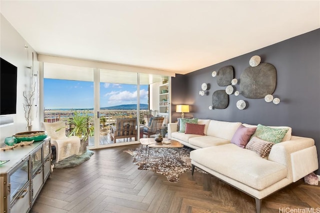 living room with floor to ceiling windows and dark parquet flooring