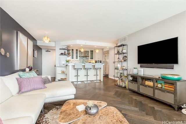 living room featuring dark parquet flooring