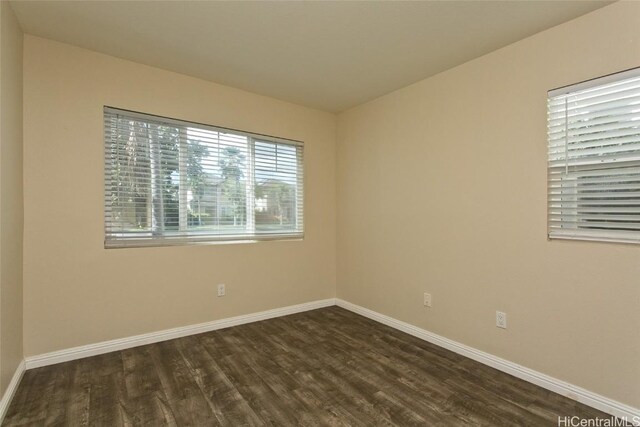 empty room with dark wood-type flooring