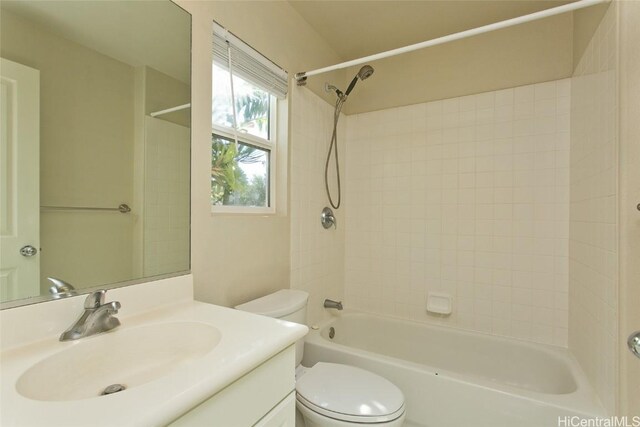 full bathroom with vanity, toilet, and tiled shower / bath