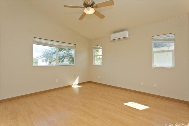 unfurnished room featuring light hardwood / wood-style flooring, a wall unit AC, ceiling fan, and lofted ceiling