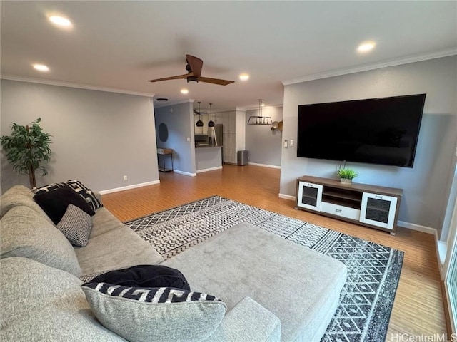 living room featuring crown molding and hardwood / wood-style floors