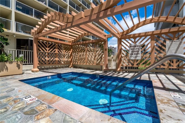 view of pool featuring a pergola and a hot tub