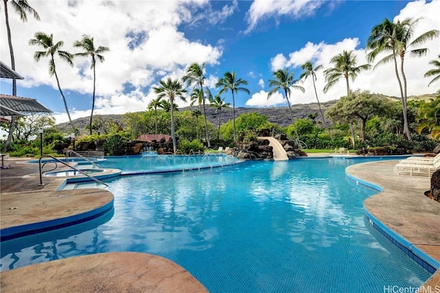 view of swimming pool featuring a patio area and a water slide