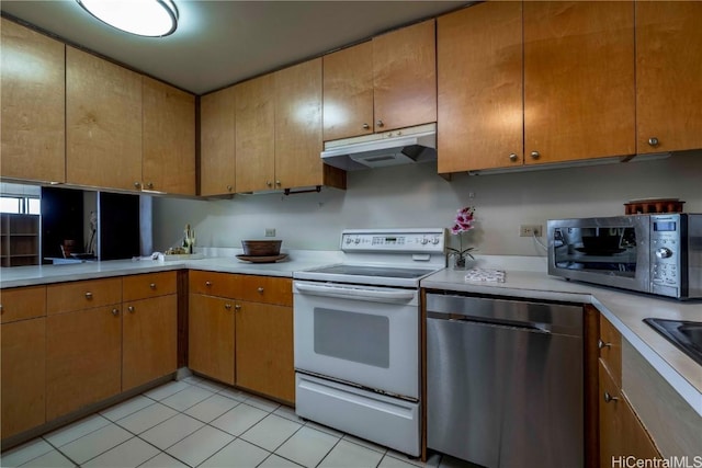 kitchen with light tile patterned flooring and stainless steel appliances