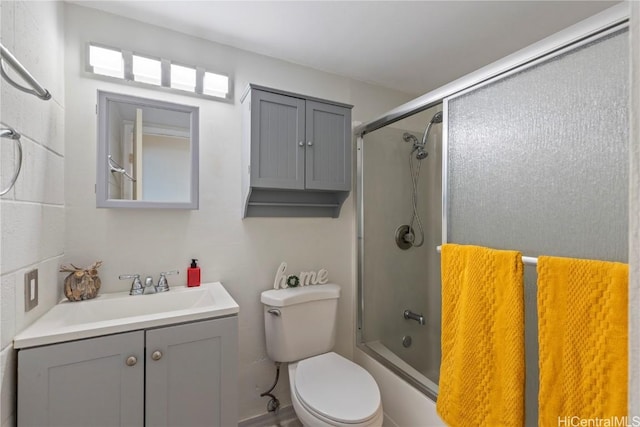 full bathroom with vanity, toilet, and shower / bath combination with glass door