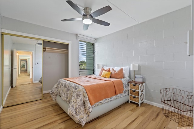 1046 Ehoeho Ave Unit 328, Wahiawa, HI 96786 - bedroom featuring light wood-style flooring, a closet, concrete block wall, and ceiling fan