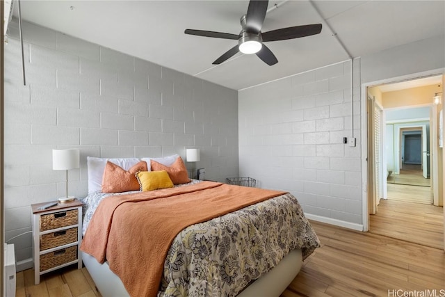 bedroom with ceiling fan and light hardwood / wood-style floors