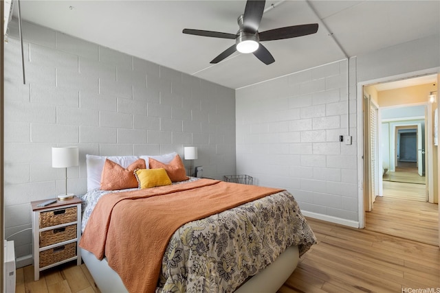 1046 Ehoeho Ave Unit 328, Wahiawa, HI 96786 - bedroom featuring concrete block wall, light wood-style floors, and ceiling fan